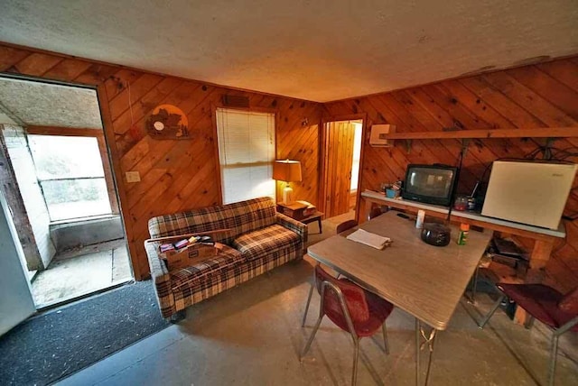 interior space featuring wooden walls and a textured ceiling