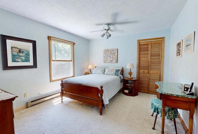 bedroom featuring ceiling fan, a closet, light carpet, and a baseboard heating unit