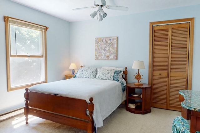 carpeted bedroom featuring a closet and ceiling fan