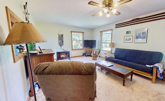 carpeted living room featuring ceiling fan