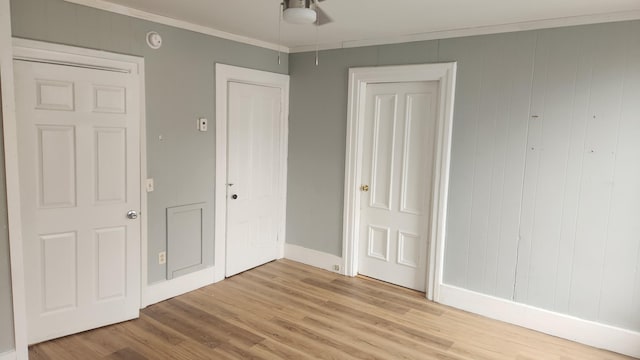 unfurnished bedroom featuring ornamental molding and light wood-type flooring