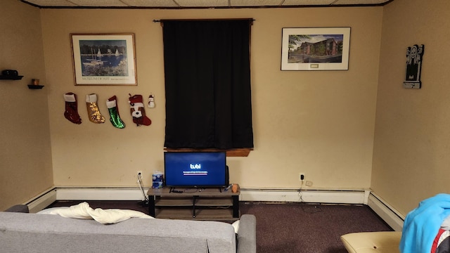 bedroom featuring a drop ceiling, carpet floors, and a baseboard heating unit