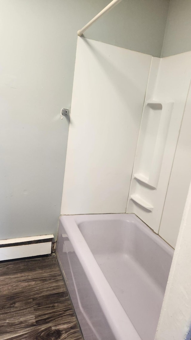 bathroom featuring wood-type flooring and baseboard heating