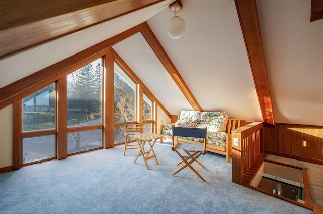 sitting room with lofted ceiling with beams and carpet