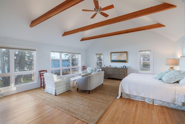 bedroom featuring ceiling fan, light hardwood / wood-style flooring, and lofted ceiling with beams