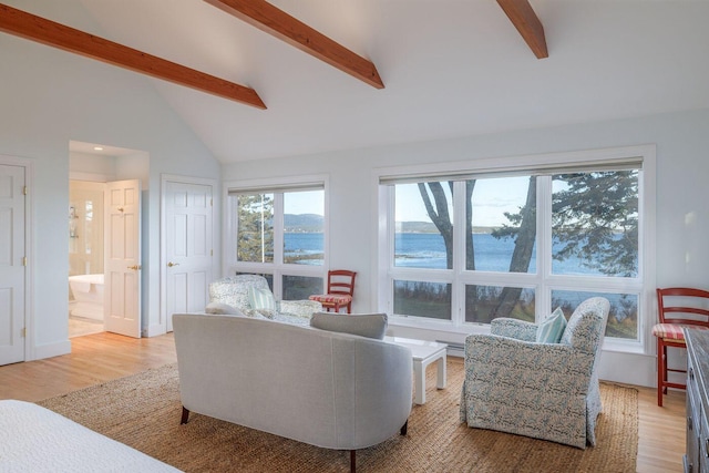 living room with a water view, vaulted ceiling with beams, and light hardwood / wood-style floors