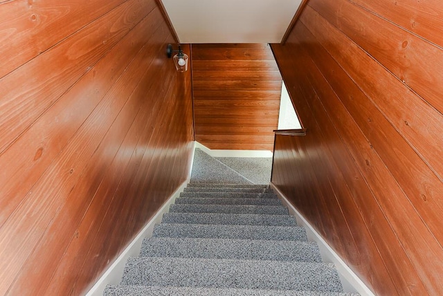 stairs featuring wooden walls