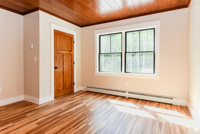 spare room featuring wooden ceiling, crown molding, a baseboard radiator, and light hardwood / wood-style floors