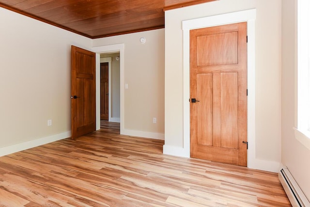 unfurnished room with baseboard heating, crown molding, wood ceiling, and light hardwood / wood-style floors