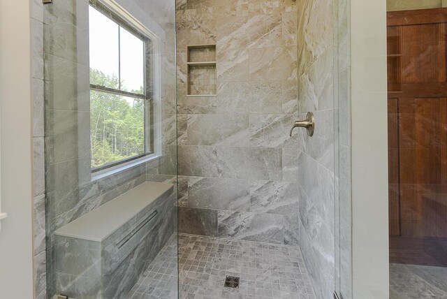 bathroom with a tile shower