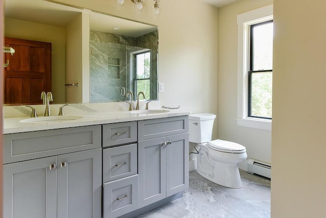 bathroom featuring an enclosed shower, vanity, toilet, and a baseboard radiator