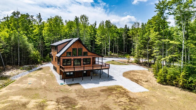 rear view of house featuring a wooden deck