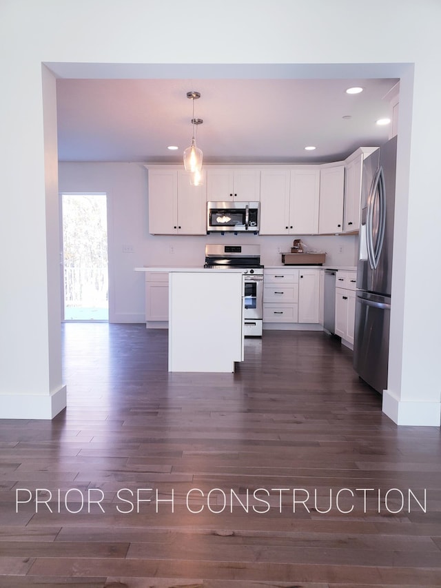 282-284 S St S, Gorham, ME 04038 - kitchen with hanging light fixtures, dark wood-style floors, stainless steel appliances, baseboards, and white cabinets