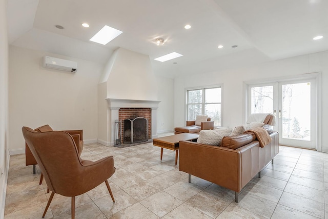 living room featuring a brick fireplace, an AC wall unit, french doors, and plenty of natural light