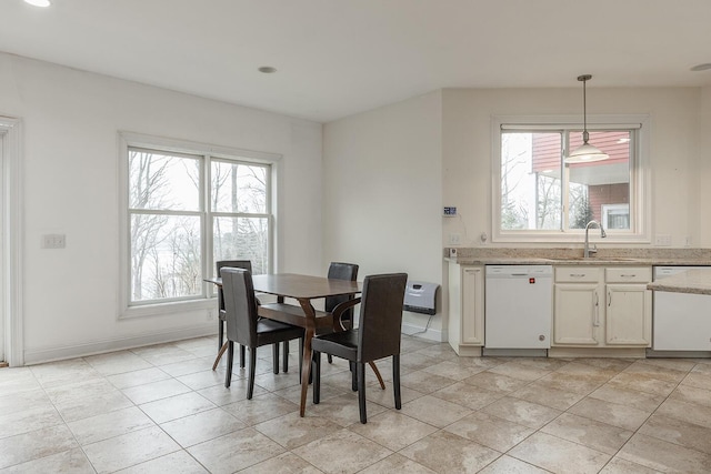 dining area featuring light tile patterned floors and sink