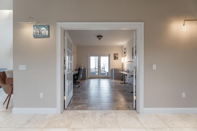 hall featuring french doors and light tile patterned floors