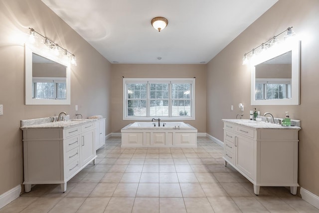 bathroom with vanity, tile patterned floors, and a bath