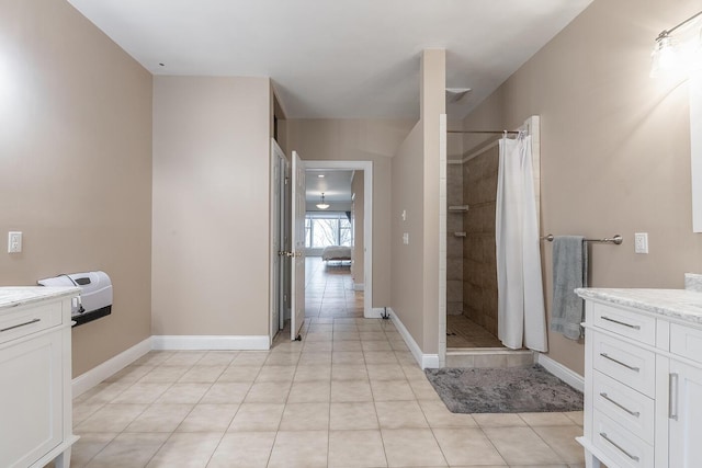 bathroom featuring vanity, walk in shower, and tile patterned flooring