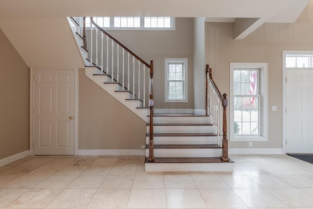 entrance foyer featuring a high ceiling and light tile patterned floors