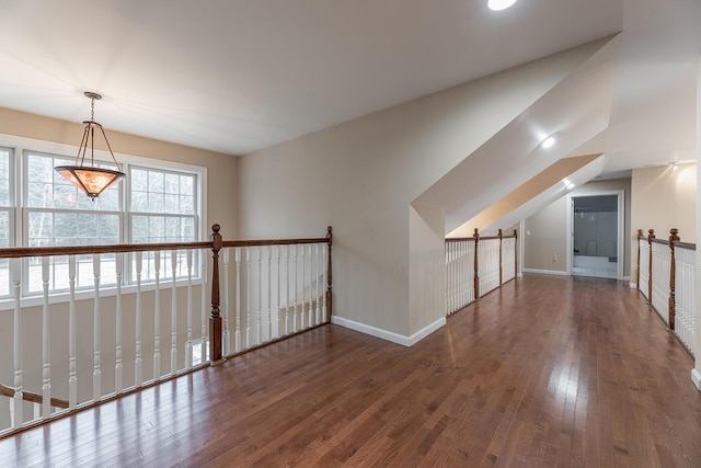 additional living space featuring lofted ceiling and dark hardwood / wood-style floors