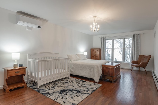 bedroom with a notable chandelier, a wall mounted AC, dark hardwood / wood-style floors, and baseboard heating