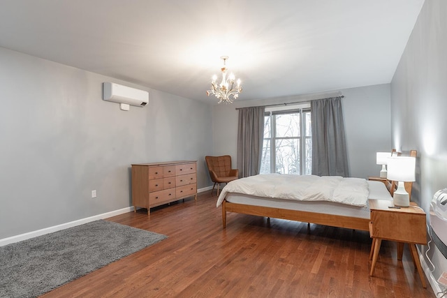 bedroom featuring a notable chandelier, dark hardwood / wood-style floors, and a wall unit AC