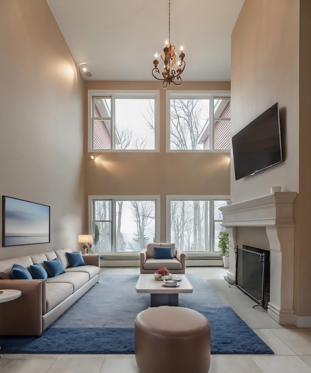 living room featuring an inviting chandelier, a towering ceiling, and plenty of natural light