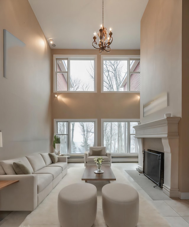 living room featuring a baseboard heating unit and a chandelier