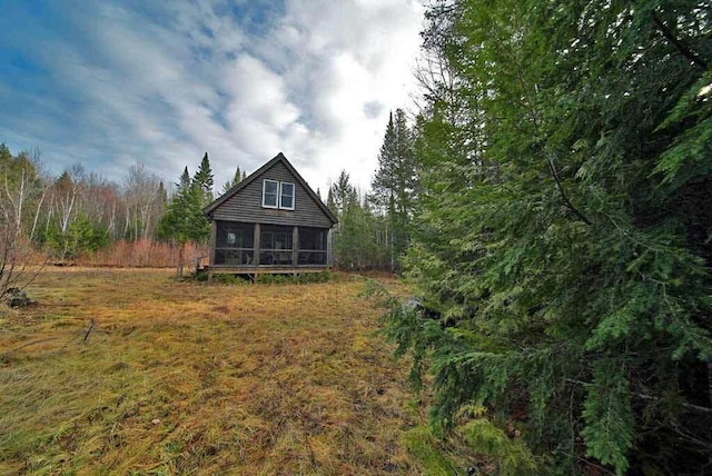 rear view of property featuring a sunroom