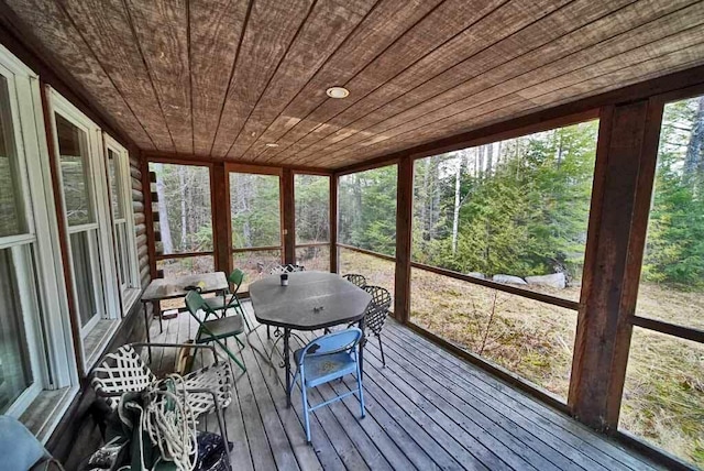 unfurnished sunroom featuring wood ceiling and a wealth of natural light