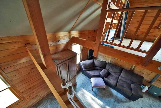 living room with wood-type flooring and wood walls