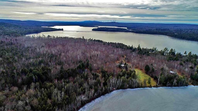 aerial view at dusk featuring a water and mountain view