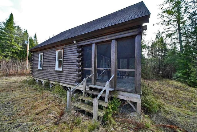 view of property exterior featuring a sunroom