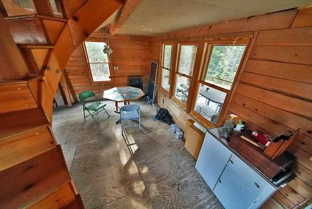 interior space featuring wooden walls and plenty of natural light