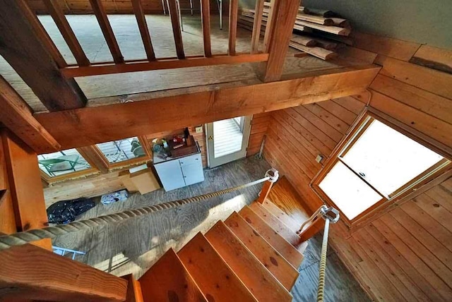 stairway featuring wooden walls