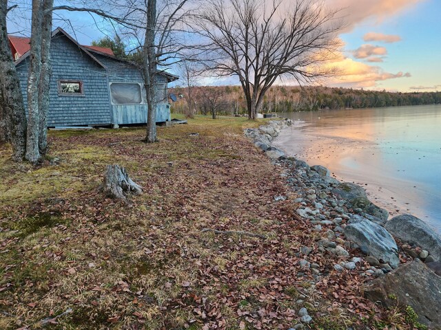 yard at dusk with a water view