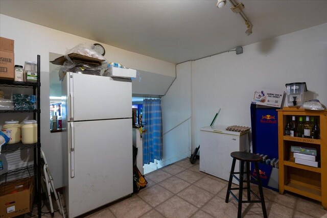 kitchen featuring white fridge and rail lighting