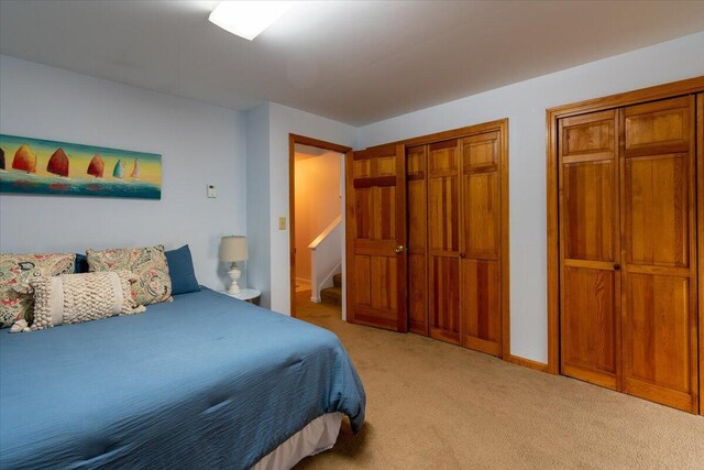 bedroom with a closet and light colored carpet