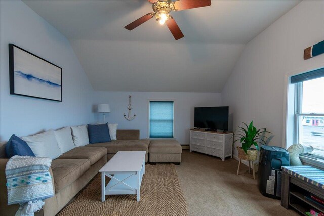 carpeted living room with lofted ceiling and ceiling fan