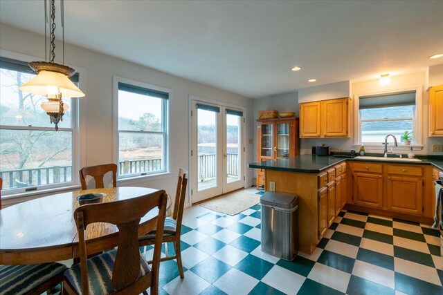 kitchen featuring sink, french doors, and pendant lighting