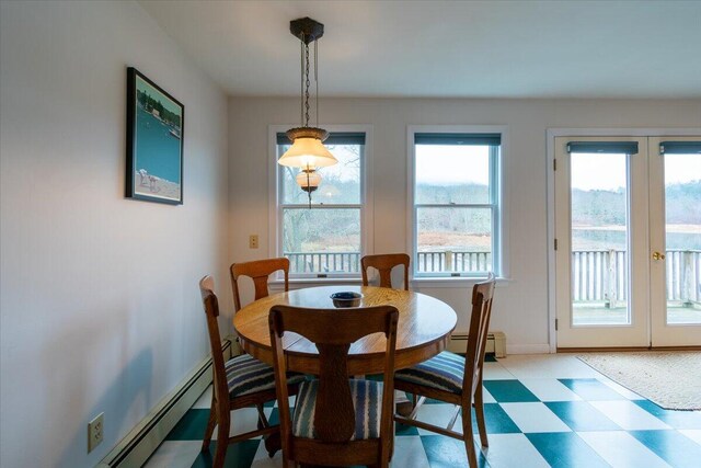 dining space with french doors and a baseboard radiator