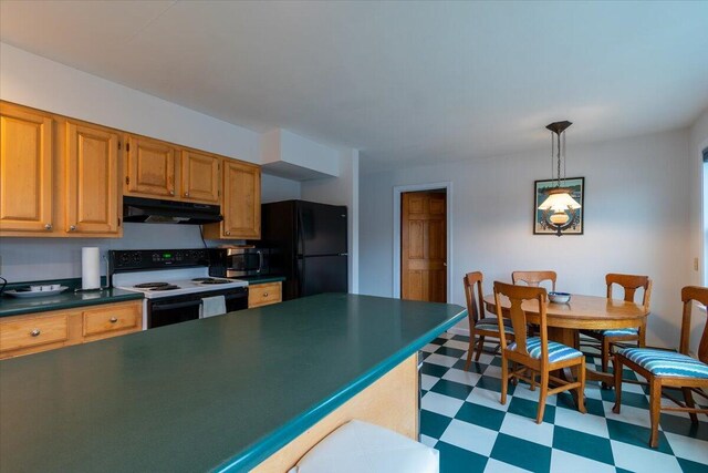 kitchen featuring hanging light fixtures, electric range oven, and black refrigerator