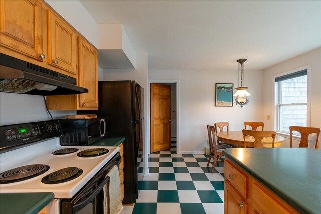 kitchen featuring electric stove and hanging light fixtures