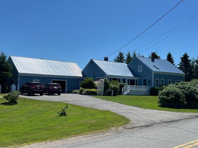 view of front of property with a garage and a front lawn