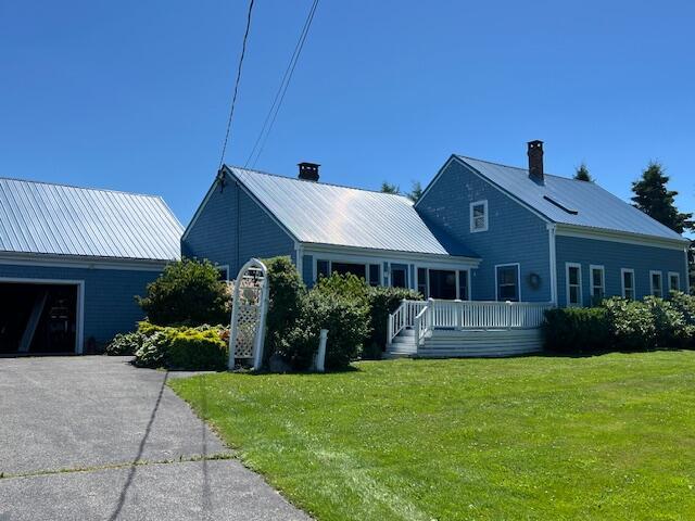 exterior space featuring a deck and a front lawn