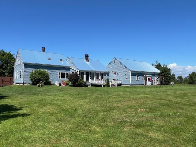 back of house featuring a lawn