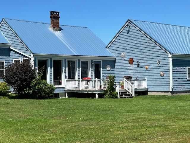 rear view of house with a yard