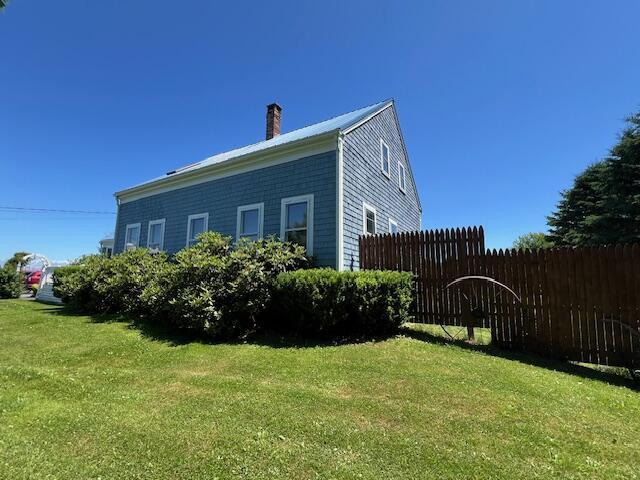 view of home's exterior with a lawn