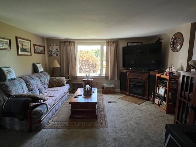 living room featuring a fireplace and carpet flooring