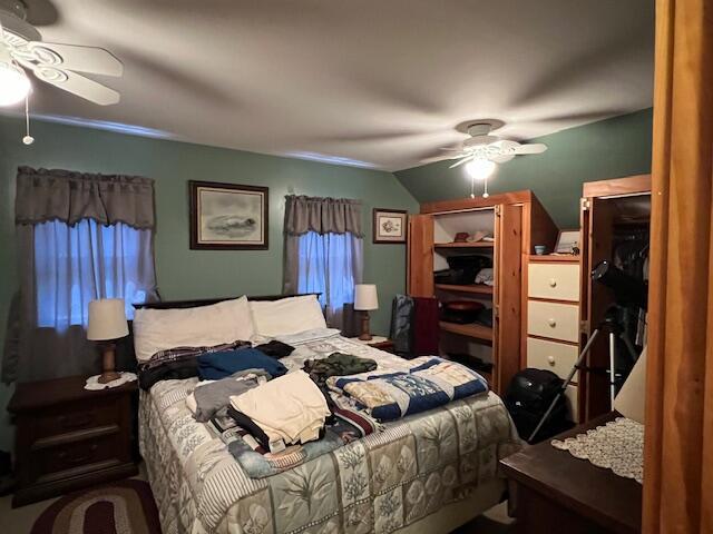 bedroom with lofted ceiling and ceiling fan